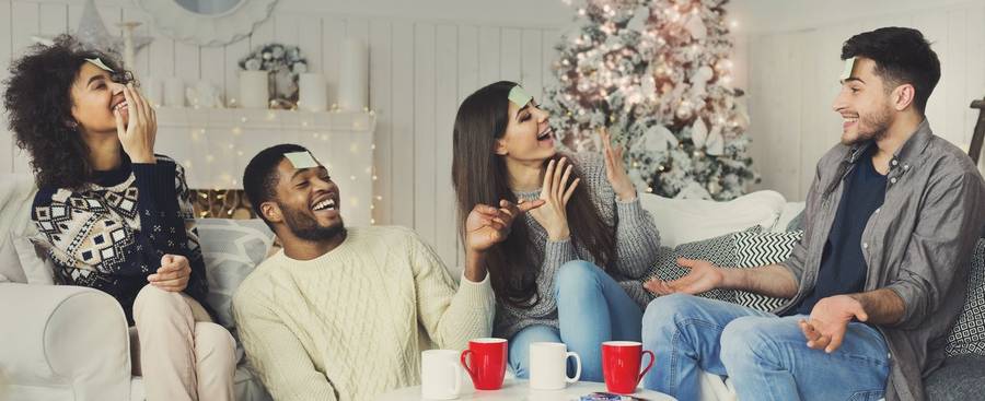 Friends laughing over a Christmas game